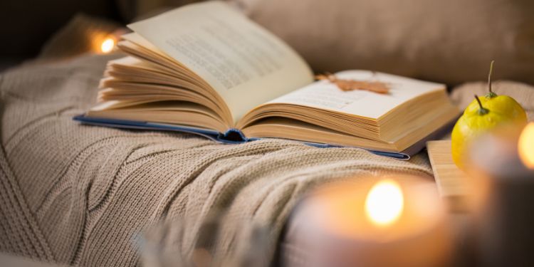 Cosy photo of a book and some candles